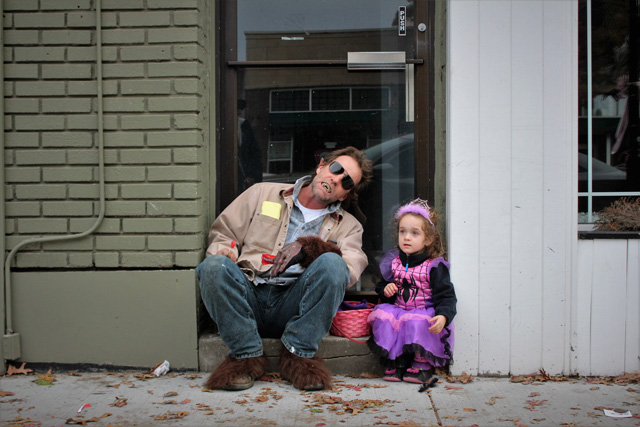 James Rooney and daughter Honora take a break from trick-or-treating to enjoy some hard-earned candy. Both from Aquebogue. James is dressed as the Big Bad Wolf and Honora is dressed as Spider Girl.