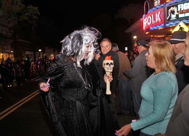 Parade characters spook the crowd by getting up close and personal.