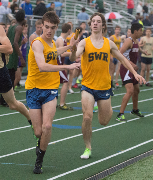 Shoreham-Wading River's Matt Gladysz hands off the baton to Connor McAlary in the 4 x 800 relay Friday. (Credit: Robert O'Rourk)