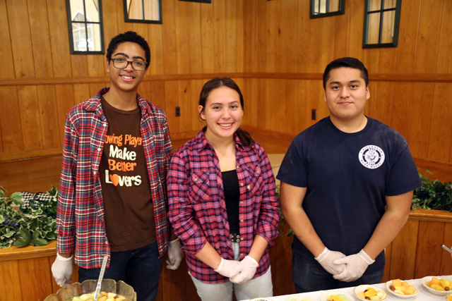 Riverhead High School students Jason Thompson and Roxana Lopez of the Interact Club, from left, with Anthony Muralles of the NJROTC.