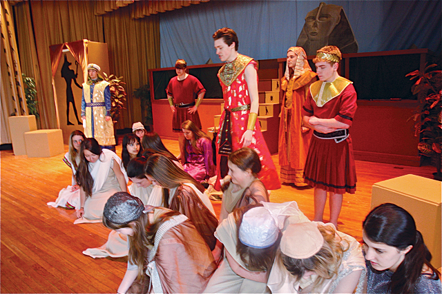Patrick O'Brien of Riverhead as Radames (in red standing), general of the Egyptian army, during the scene with slaves including Aida (front row far right) after she was captured. (Credit: Barbaraellen Koch)