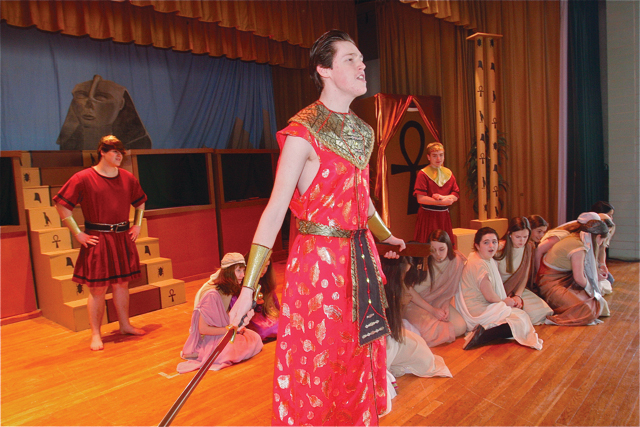Patrick O'Brien of Riverhead as Radames (in red standing), general of the Egyptian army, during the scene with slaves called 'dance of the robes.' (Credit: Barbaraellen Koch)