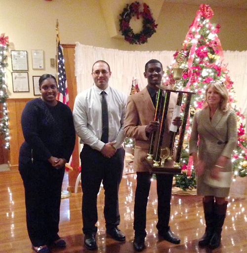 McGann-Mercy senior Reggie Archer received the 2014 Boden Award Dec. 5. He's pictured with his mother (left), football coach Phil Lombardi and Denise Boden. (Courtesy photo)