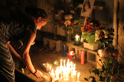 Brittany Rocco lights a candle at a memorial for Amy (Credit: Jen Nuzzo)