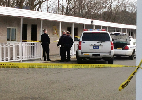 Police investigate outside room 136 of the Greenview Inn on West Main Street in Riverhead.