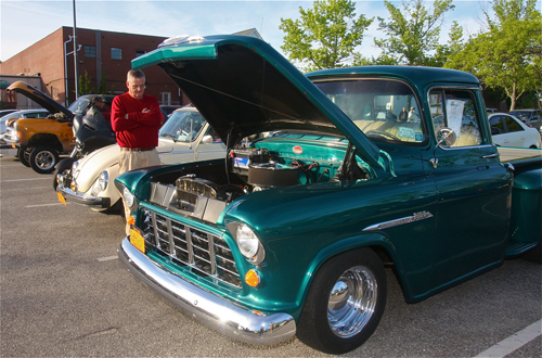 Larry O'Toole of Hampton Bays looks a a 1955 Chevrolet 3100 pickup truck. (Credit: Barbaraellen Koch)