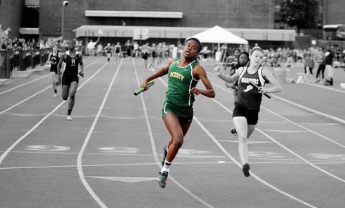McGann-Mercy senior Danisha Carter crosses the finish line first in the 4 x 100 heat at Friday's state championship. (Credit: Hal Henty)