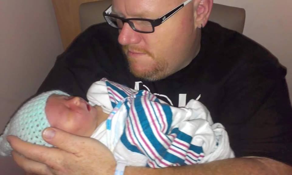 David Decarle of Riverhead holding his newborn son, Desmond James, last year. (Courtesy photo)