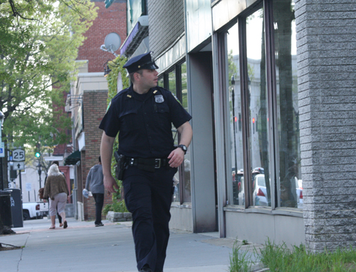 A Riverhead police officer walks the beat downtown on Monday night. (Credit: Barbaraellen Koch)