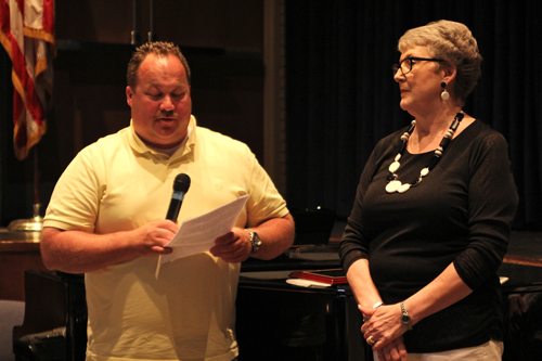 Riverhead school board vice president Greg Meyer honoring Ann Cotten-DeGrasse during last month's meeting. (Credit: Jennifer Gustavson, file)
