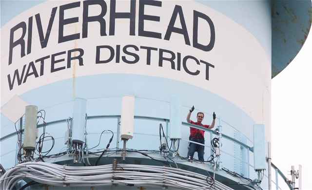 Riverhead Town Supervisor Sean Walter climbed the Riverhead water tower Wednesday morning. (Credit: Barbaraellen Koch)