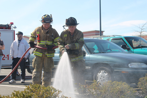 PAUL SQUIRE PHOTO | (R-L) Riverhead firefighters Skip Beale and Chris Schroer put out a mulch fire Sunday afternoon.
