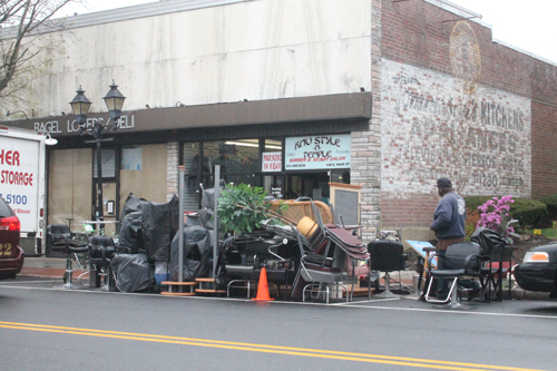 PAUL SQUIRE PHOTO | Workers clean out the Knu Style-N-Temple barber shop on East Main Street Tuesday morning.