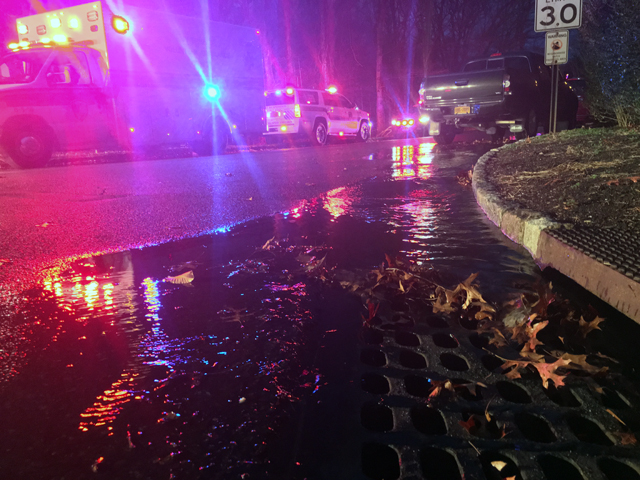 Water from firehoses runs into a drain on Moet Drive on Sunday evening. (Credit: Vera Chinese)