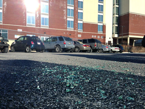 PAUL SQUIRE PHOTO | Glass on the rear parking lot behind the Treasure Cove Marina and Hyatt Hotel. 