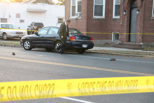 PAUL SQUIRE PHOTO | A Riverhead detective investigates the scene of the East Main Street car accident that seriously injured an elderly pedestrian Friday afternoon.