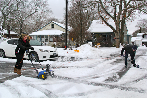 Brother and sister, Kayla and Christian Hojeski, clear their family's driveway.