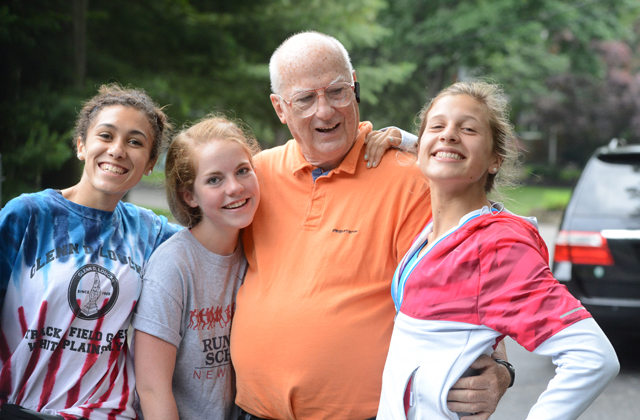 Coach Koretzki poses with three of his runners during the 2014 SWR July 4 5K race. (Credit: Robert O'Rourk)