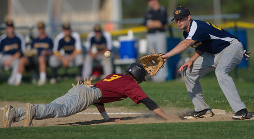 GARRET MEADE PHOTO | Riverhead's Michael; Brosseau dove safely back to the bag before North Fork first baseman Mike Hayden could slap a tag on him.