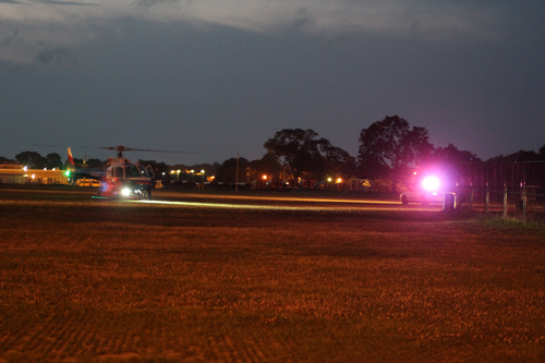 A county police helicopter prepares to airlift a crash victim near Pulaski Street School in Riverhead Sunday night. (Credit: Jennifer Gustavson)