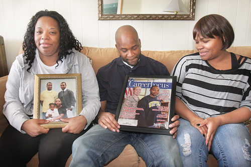 BARBARAELLEN KOCH PHOTO  |  Demitri Hampton's sister Jennifer Davis (left), brother Jamal Davis and first cousin Latisha Diego with photos of Demitri, who appeared on the cover of a Suffolk Community College campus magazine in 2012, during a meeting with reporters in Polish Town Tuesday.