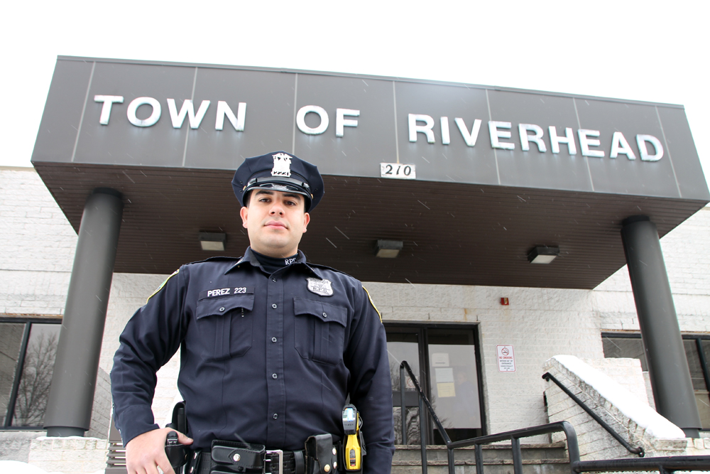 Byron Perez, the first full-time Hispanic cop on the town's police force and a lifelong Riverhead resident, says his goal is to give back to his hometown. As a volunteer instructor with Riverhead Commmunity Awareness Program, he serves as a positive role model for local students.