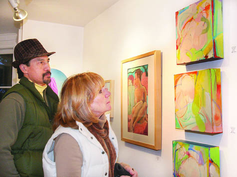 Denis Yuen and Karen Fellows of Aquebogue take a close look at the best in show acrylic paintings titled ‘M'lady 1, 2 and 3’ by Barbara Groot of East Hampton at the East End Arts Council gallery in Riverhead. Other winners in the juried show ‘Women: The Eternal Artist’s Muse and Inspiration’ that opened March 4 include  Anne Seelbach of Sag Harbor, first place; Gena Griffiths of Cutchogue, second; and Gary Bartoloni of Greenport, third. The show runs through April 15.