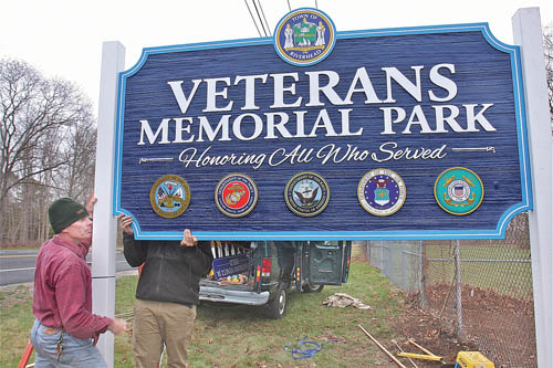 Wedel Signs workers installing the Veterans Memorial Park last April in Calverton. (Credit: Barbaraellen Koch photo)