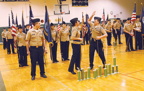 PAUL SQUIRE PHOTO  |  Ensign Thomas Kopp watches as Lt. Amanda Gallo and Ensign Harold Hubbard high five after Riverhead was announced as the winner of the annual drill meet in Mastic Saturday afternoon.