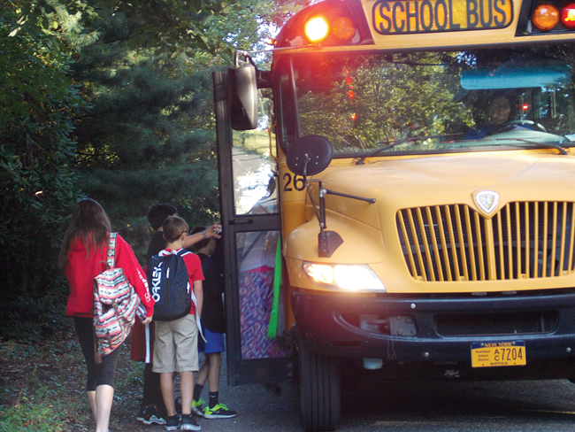 Ten students board a school bus at Hulse Avenue and 17th Street Monday morning. (Credit: Joseph Pinciaro)