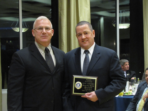 Captain Richard Smith, left, presents Det. Frank Hernandez with Riverhead's Officer of the Year Award Friday