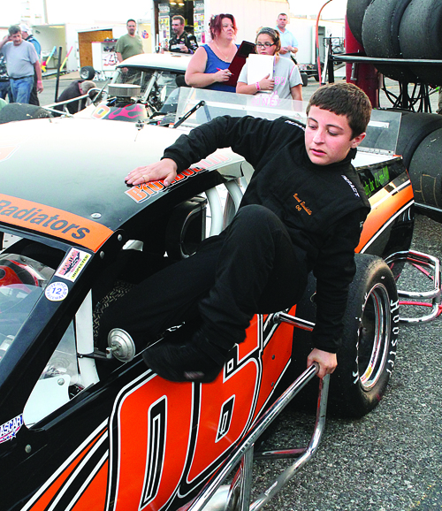 PAUL SQUIRE PHOTO | Vincent Biondolillo hops into his team's #06 car Saturday at Riverhead Raceway.