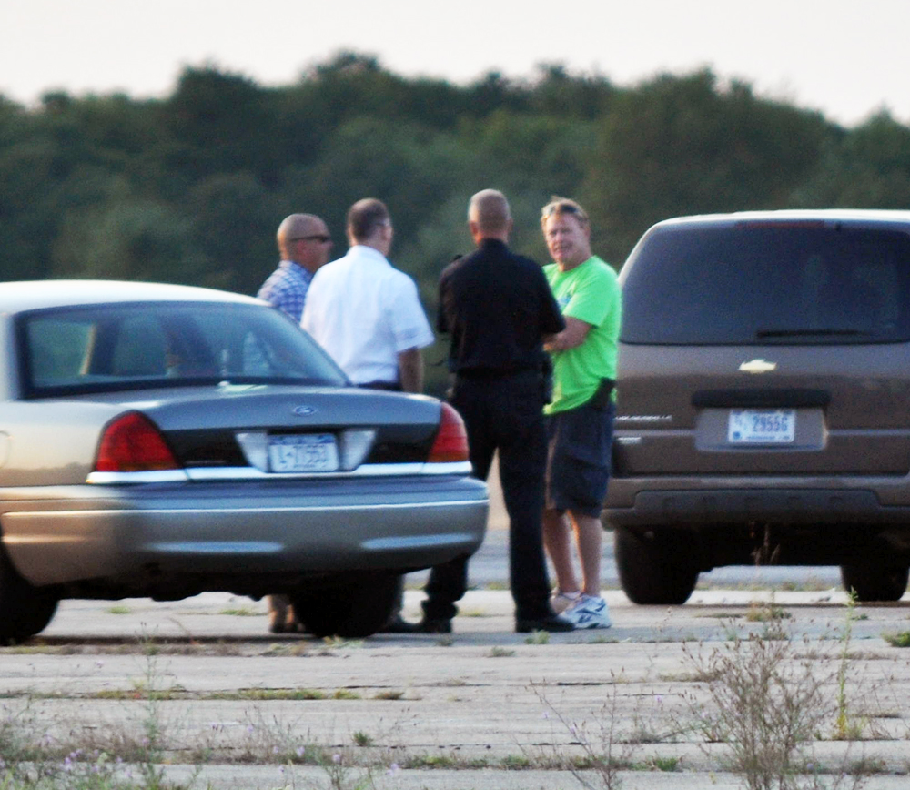 Skydive Long Island owner Ray Maynard speaks with investigators at the scene Wednesday evening. (Credit: Grant Parpan)