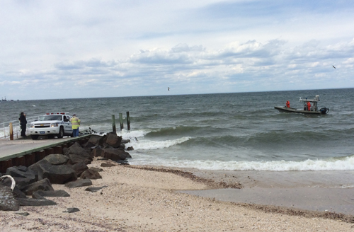 A police boat returns to the shore after officers were unable to locate a sailboat that had issued a distress call Sunday afternoon. The U.S. Coast Guard is continuing the search. (Credit: Grant Parpan)