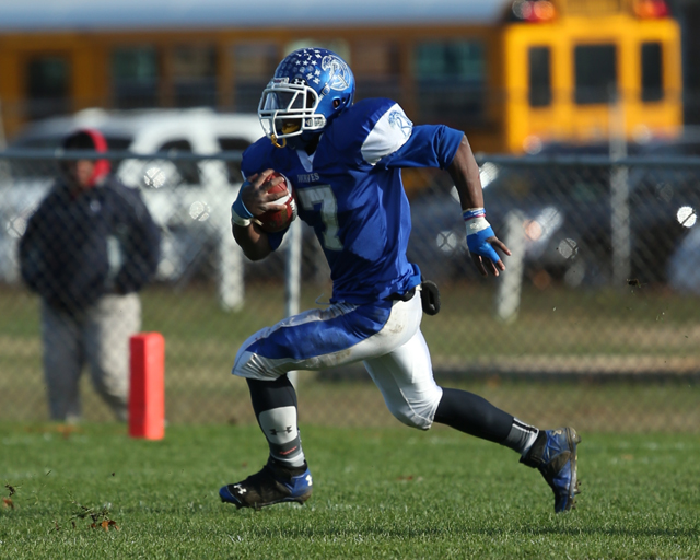 Riverhead running back Ryun Moore picks up a first down in the Blue Waves' playoff win against Deer Park Saturday. (Credit: Daniel De Mato)