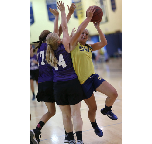Shoreham-Wading River Alex Hutchins faces double-team pressure during her the Wildcats' 43-30 win over Sayville. (Credit: Garret Meade)