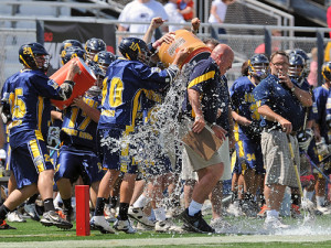 DAVE ANDERSON PHOTO | Shoreham-Wading River coach Tom Rotanz gets dumped with water after the Wildcats' Long Island championship victory last spring.