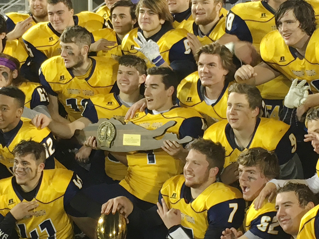 The Shoreham-Wading River players celebrate their victory Saturday. (Credit: Joe Werkmeister)