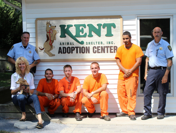 Suffolk County Corrections Department officers Sergeant Jeff Campo and Phil Cantora and volunteers with Pamela Green of Kent Animal Shelter. (Credit: Courtesy Photo)