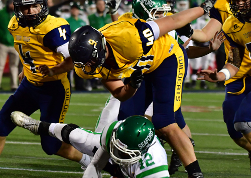 Ethan Wiederkehr records a sack in the Wildcats' Long Island Championship win. (Credit: Robert O'Rourk, file)
