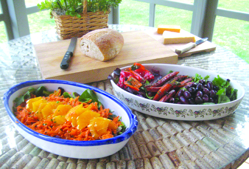 Moroccan carrot orange salad (left) and carrot confit served over arugula with roasted peppers and olives.