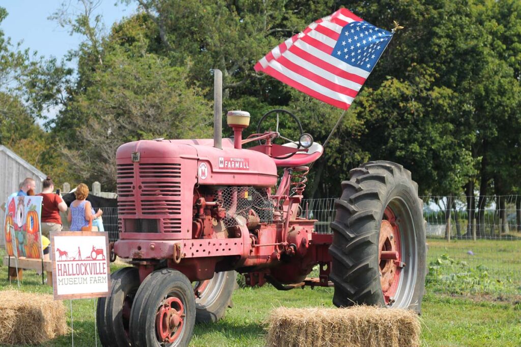 Tractor with American flag waving at Hallockville Country Fair