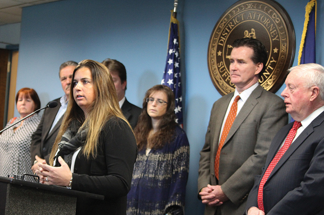 Melanie Stafford speaks at a press conference in Hauppauge Tuesday with Suffolk County District Attorney Thomas Spota (far right), state Senator John Flanagan (second from right) and family members of hit-and-run victims. Ms. Stafford's uncle was killed in 2012 while crossing the street in downtown Riverhead. (Credit: Jen Nuzzo)