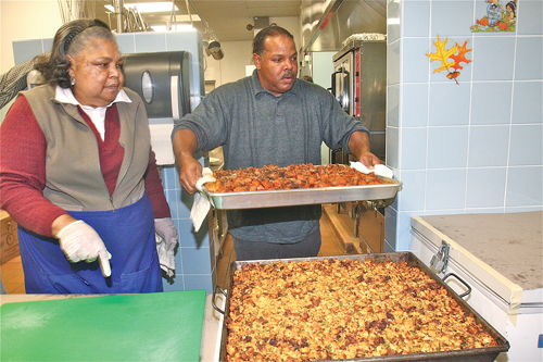 Long Island Council of Churches office manager Carolyn Gumbs and volunteer MIchael Lacy of Shinnecock Reservation in Southampton preparing side dishes for the annual Migrants Dinner last November. (Credit: File)