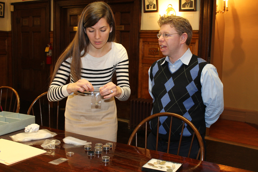 Fraunces Tavern Museum director Jessica Phillips reviews the 20 donated items as Brad Bocksel stands by and fields questions. (Credit: Bocksel family)