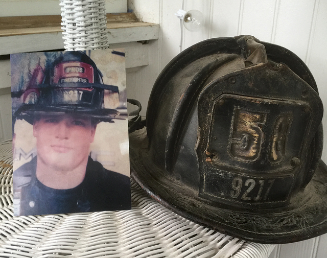 A picture of Mr. Brickman from his first year on the job displayed next to his original helmet with Engine 58. (Credit: Joe Werkmeister)