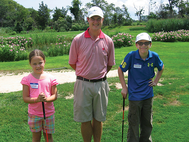 The Cedars Golf Club professional Jimmy McLaughlin with two members of the Cedars Kids Club, Aiko Fujita, left, and Michael Wineberger. (Credit: Jay Dempsey)