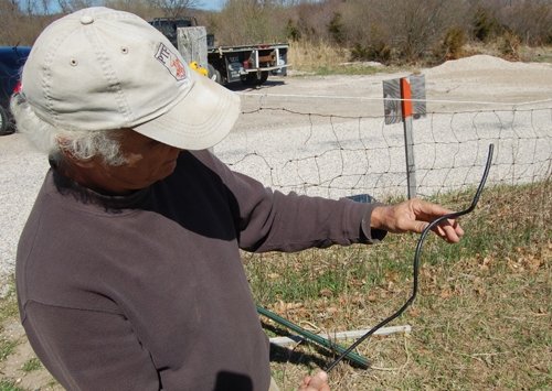 Albert Bengolea holds up one of the fence wires that was cut on the 4-H property. (Credit: Grant Parpan)