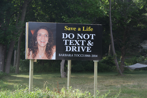 A sign on Route 24 warns drivers of the dangers of texting and driving following the death of Barbara Tocci on the road earlier this year. (Credit: Carrie Miller)