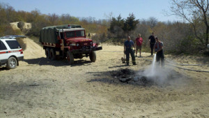 JAMESPORT FIRE DEPARTMENT COURTESY PHOTO | Firefighters extinguish a rekindled bonfire on Saturday.